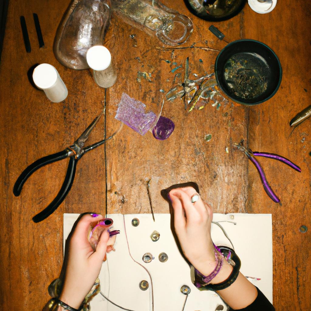 Person crafting jewelry with tools