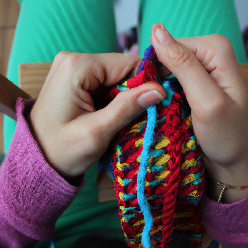 Person knitting with colorful yarn