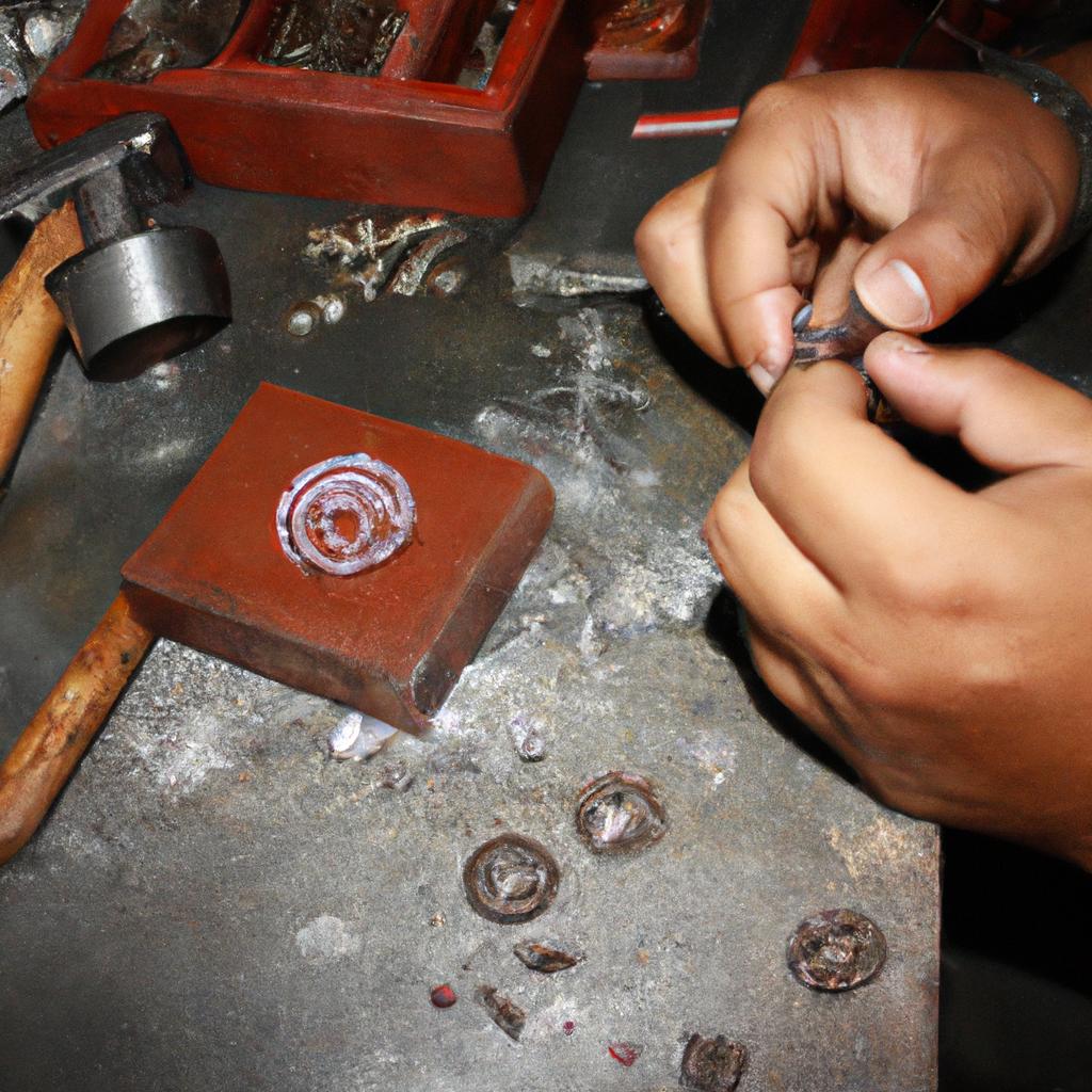 Person crafting intricate metal jewelry